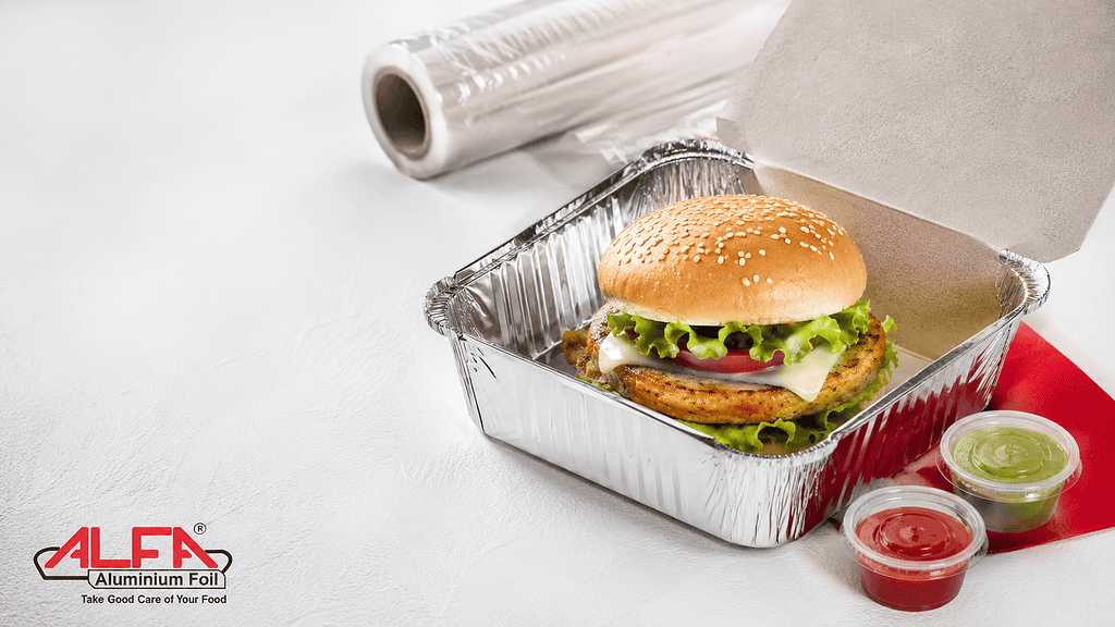 Burger delivery packaging — aluminium foil container with a burger and sauce cups